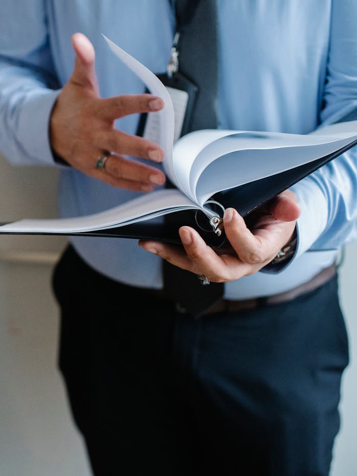 pexels-photo-5668837 Businessman reading documents in office